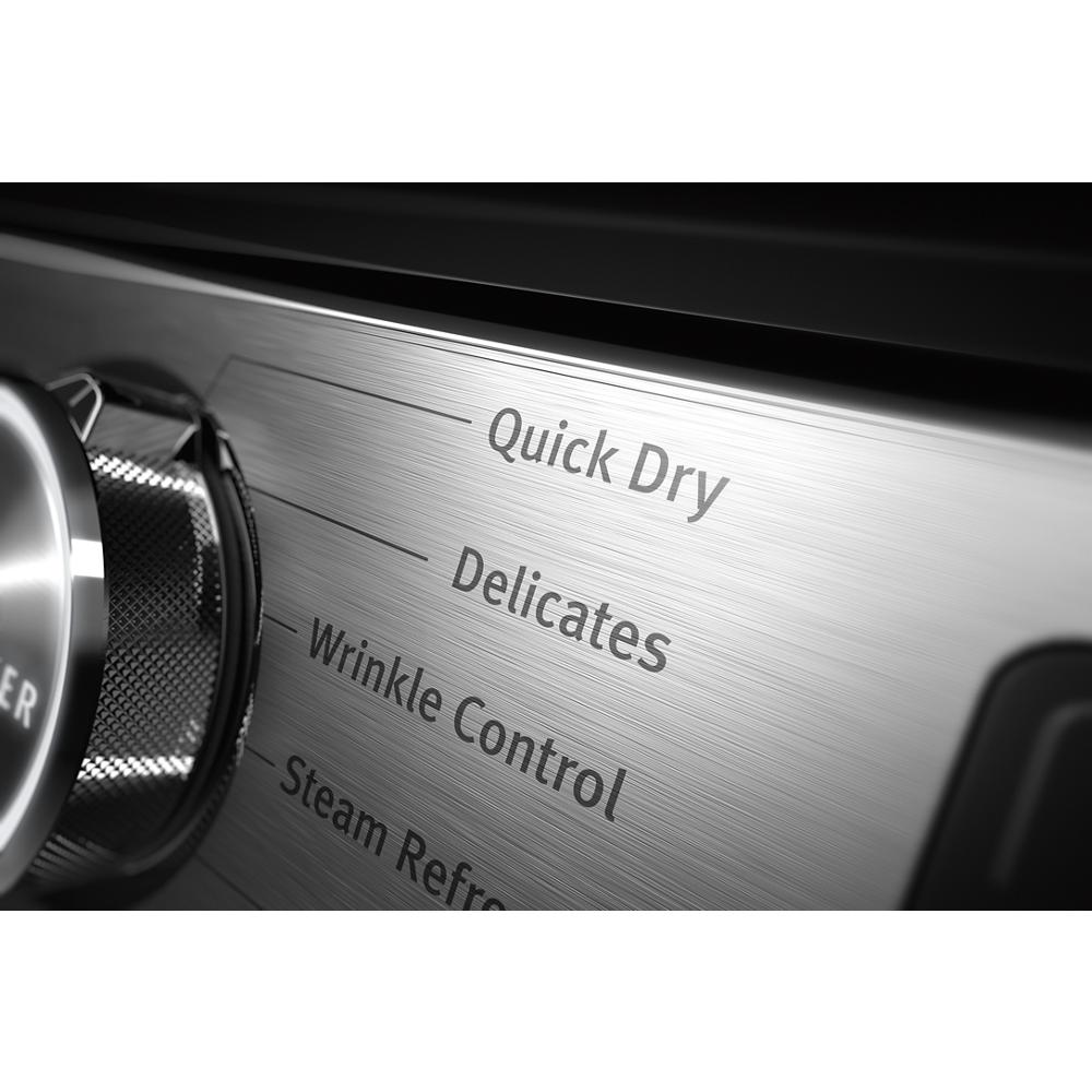 Close-up of brushed metal control panel showing Quick Dry, Delicates, Wrinkle Control, and Steam Refresh settings on dryer
