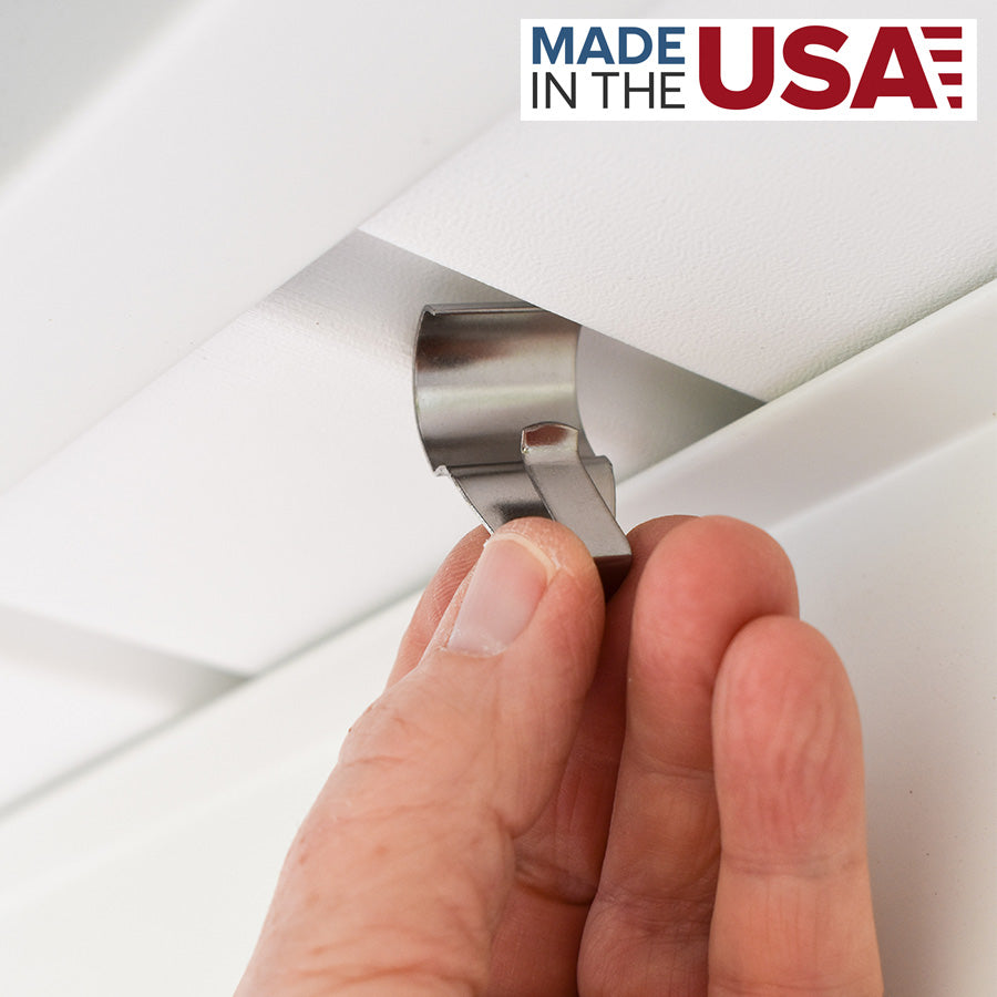 Hand inserting a metal soffit hook onto white outdoor soffit panel for secure hanging, fasteners collection under $25
