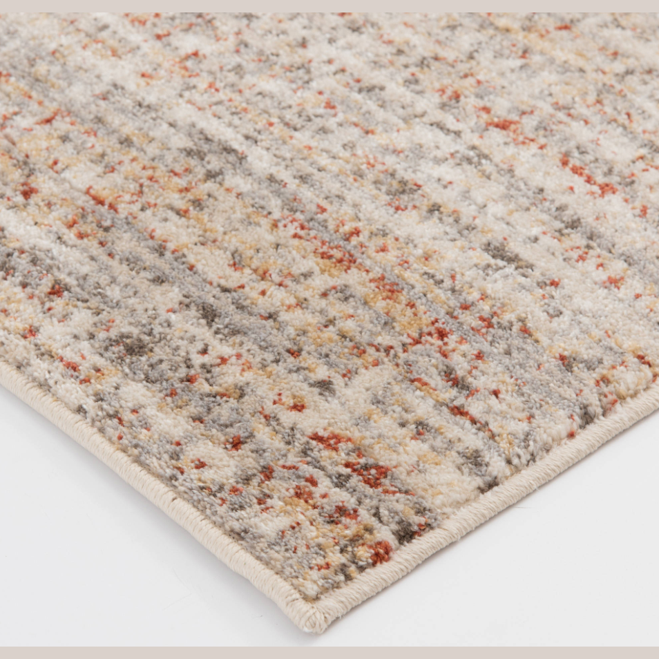 Close-up of textured area rug in soft cream, rust, blue, yellow, and green hues for home decor and flooring collections