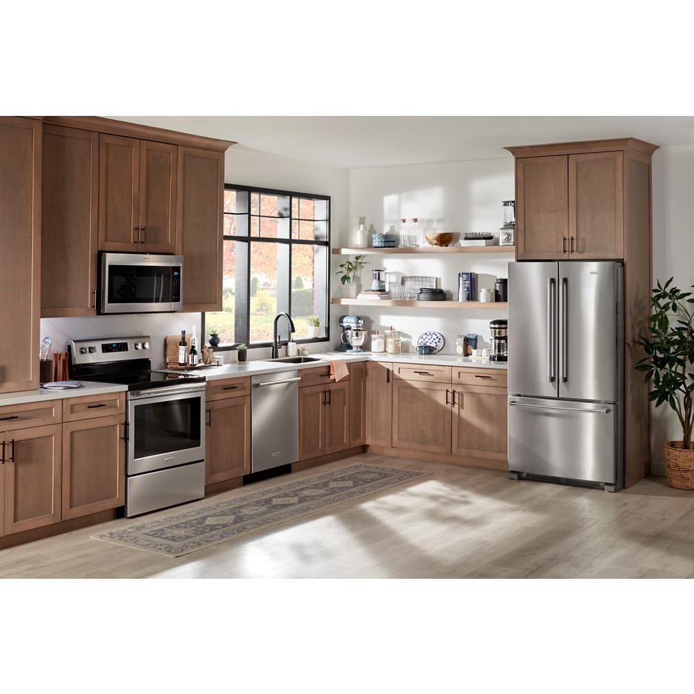 Modern kitchen featuring stainless steel French door refrigerator with bottom freezer and wood cabinetry for home improvement