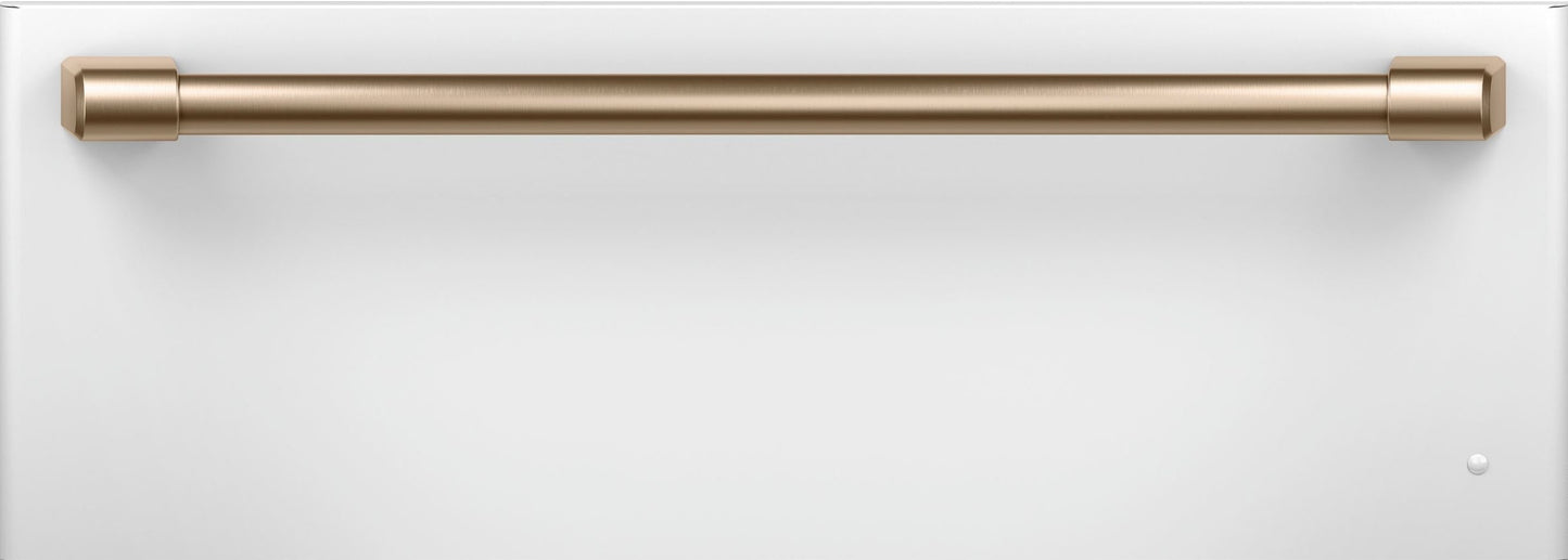 White warming drawer front with sleek brass handle, designed for modern kitchen appliances and wall ovens collections