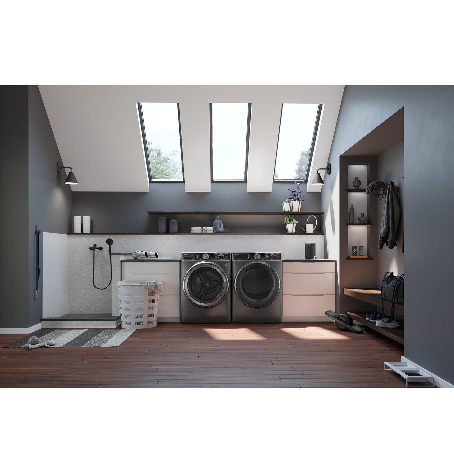 Modern front load washer and dryer set in a spacious laundry room with skylights, hardwood floor, and neat storage shelves.