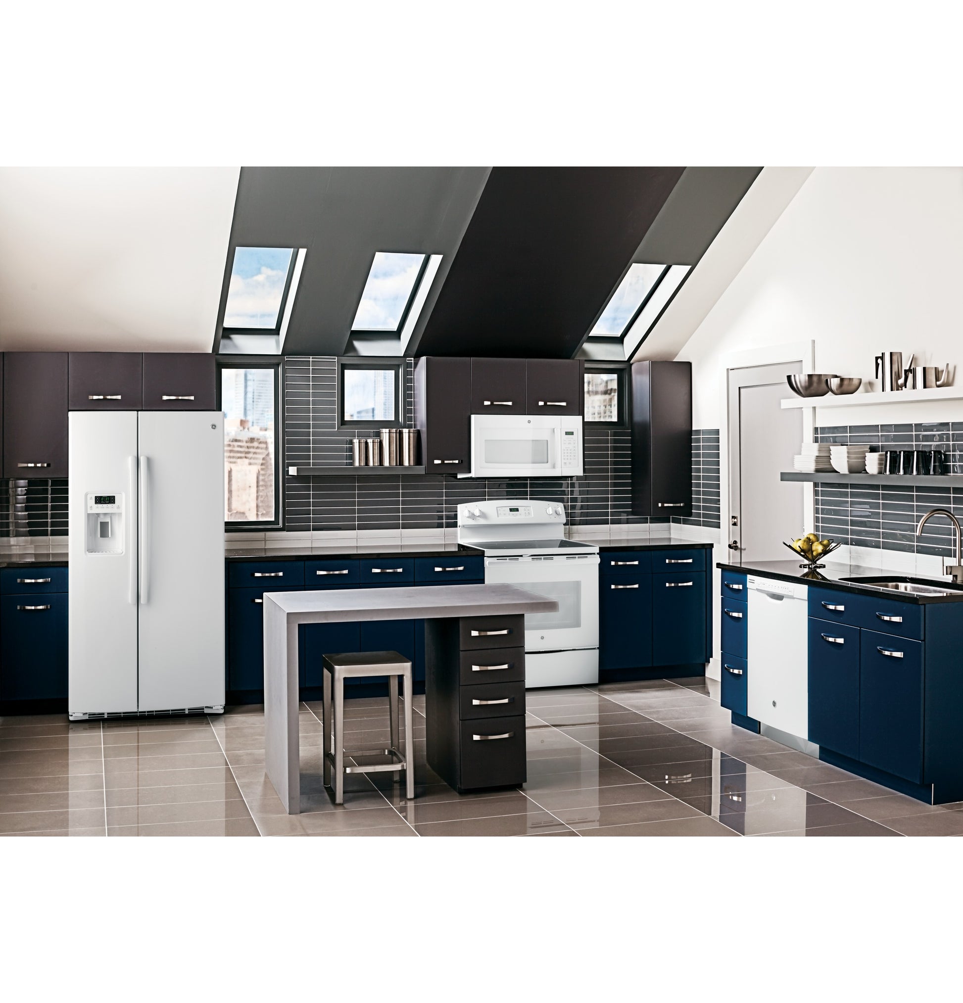 Modern kitchen featuring white over-the-range microwave, navy and dark wood cabinets, and stainless steel refrigerator in appliances collection