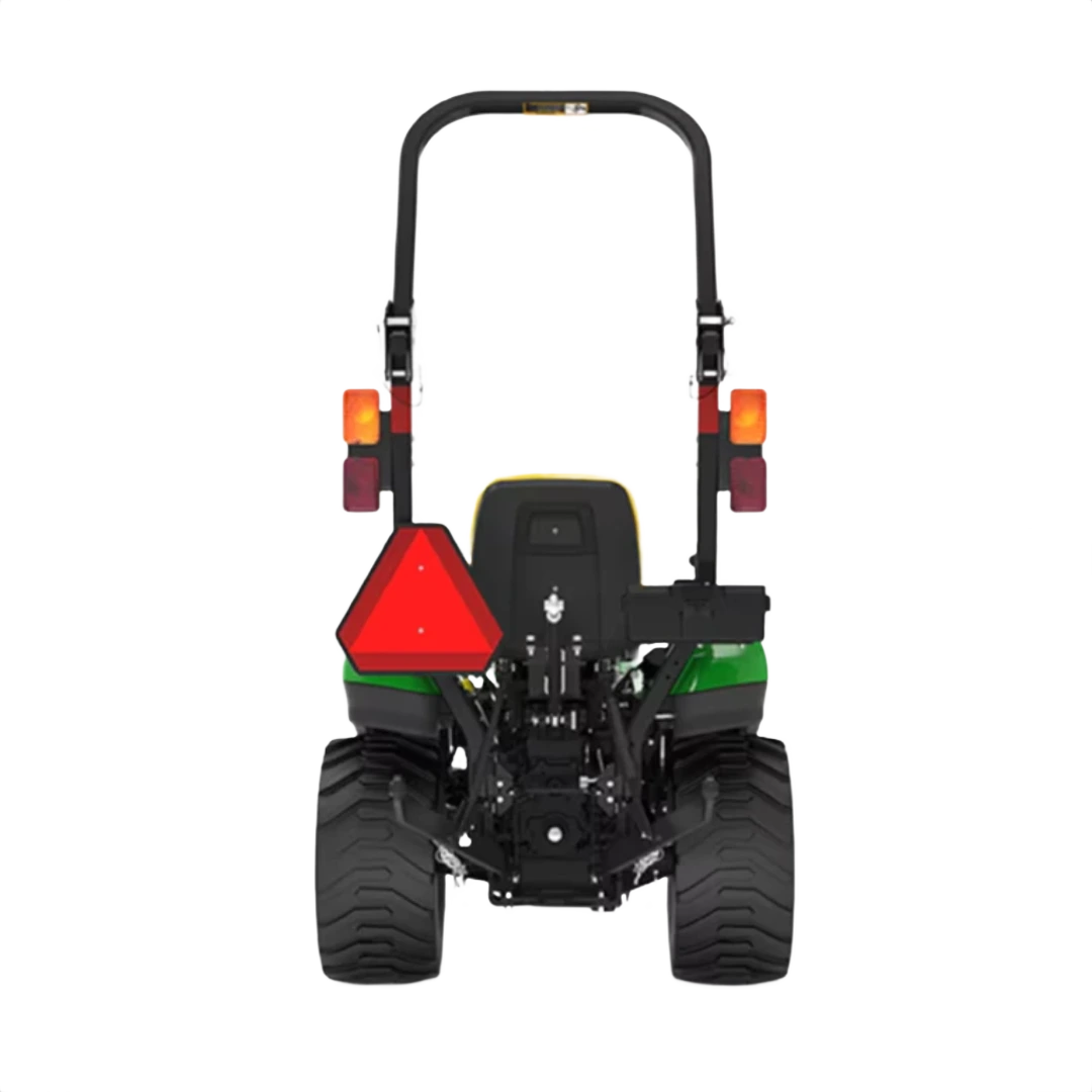 Rear view of green and yellow compact utility tractor with wide tires, safety triangle, and roll bar for home improvement tasks
