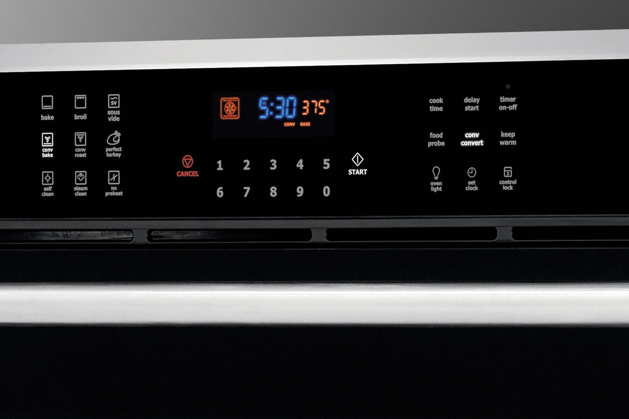 Close-up of digital control panel with IQ-Touch™ display on black and stainless steel wall oven in kitchen appliances collection