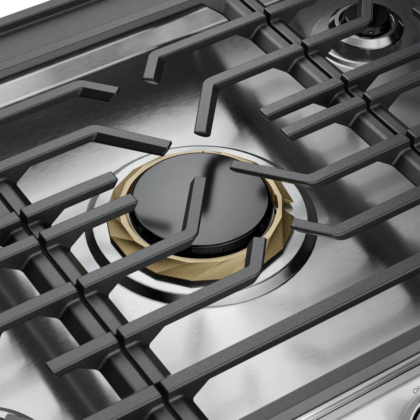 Close-up view of a stainless steel gas cooktop burner with dishwasher safe grates, part of Cooktops and Kitchen & Kitchenware collections.