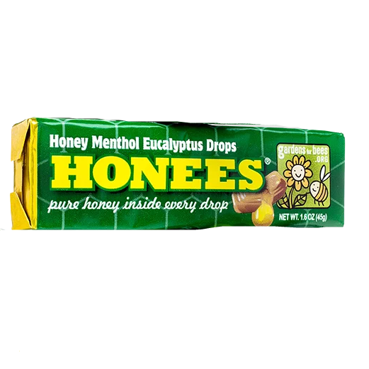 Green and yellow box of honey menthol eucalyptus cough drops with honey-filled drops in candy and food collection