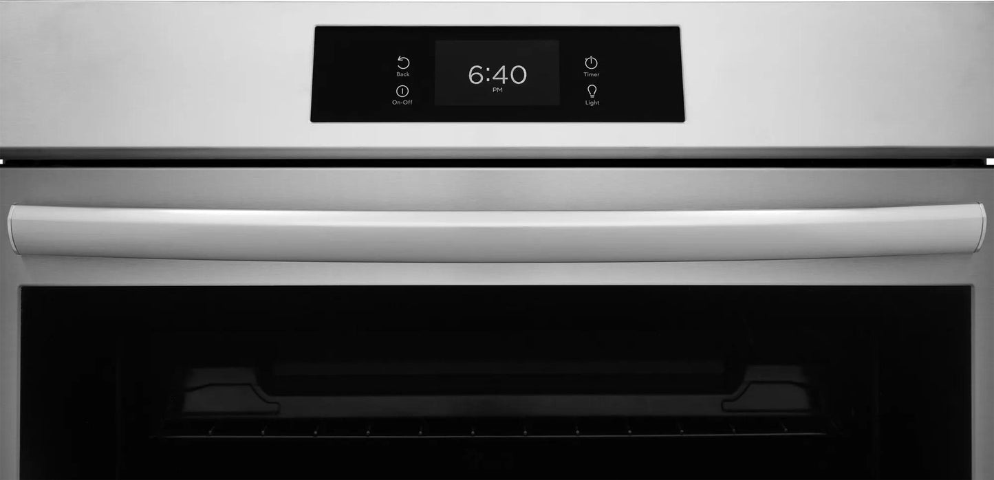 Close-up of a stainless steel front control induction range with digital clock display in kitchen and home appliances collection