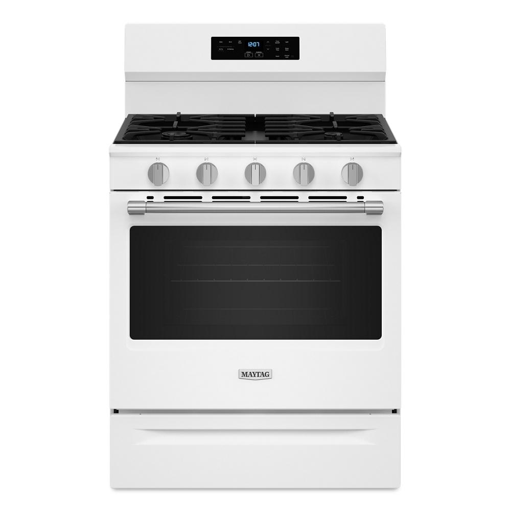 White freestanding gas range with five control knobs and digital display for kitchen appliances and cookware collections