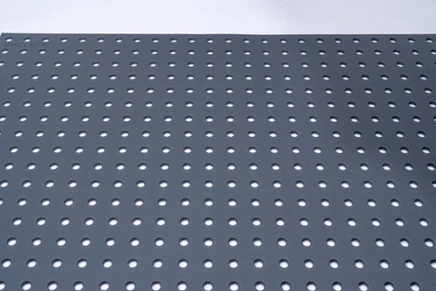 Slate-colored drawer liner with evenly spaced circular perforations for organization and tool storage use