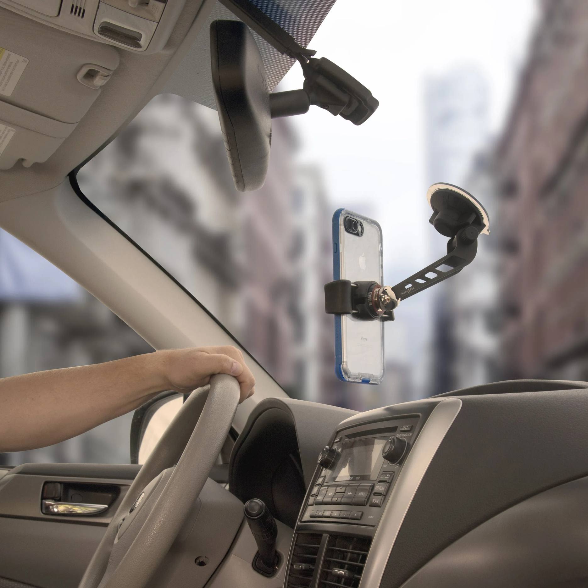 Vehicle interior showing phone attached to windshield with adjustable FreeMount kit from Wire and Electrical collection