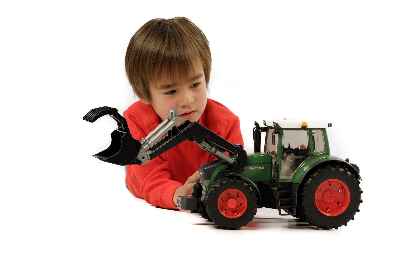 Child playing with green Bruder Fendt 936 Vario toy tractor with front loader in Vehicles & Remote Controlled Toys collection