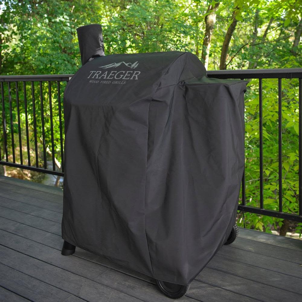 Black full-length weather-resistant grill cover with Traeger logo, designed for outdoor grill protection and grilling accessories collections