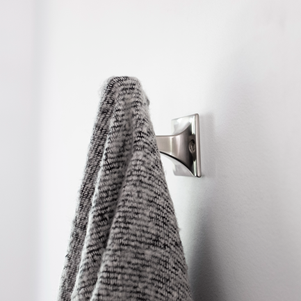 Satin nickel long robe hook mounted on wall holding a gray textured towel in bathroom setting under $50 collection