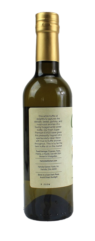 Tall glass bottle with gold cap containing white truffle infused olive oil and detailed product label on back