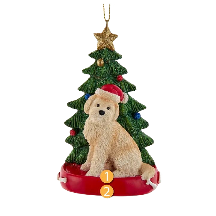 Goldendoodle figurine wearing a Santa hat sitting in front of a decorated evergreen tree with a gold star topper
