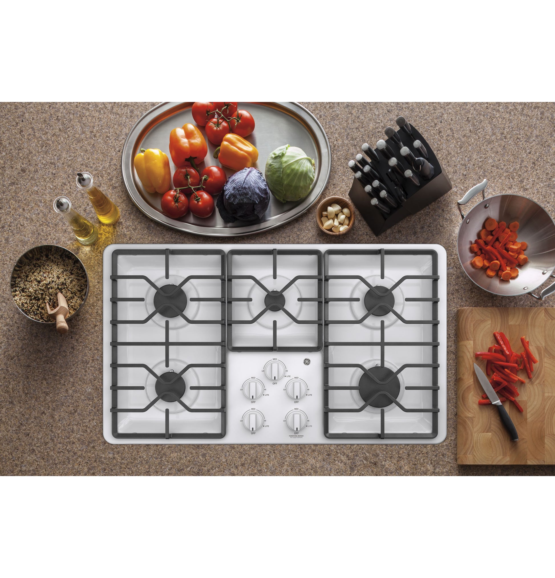 Top view of white 36-inch built-in gas cooktop with five burners and dishwasher-safe grates from kitchen appliances collection