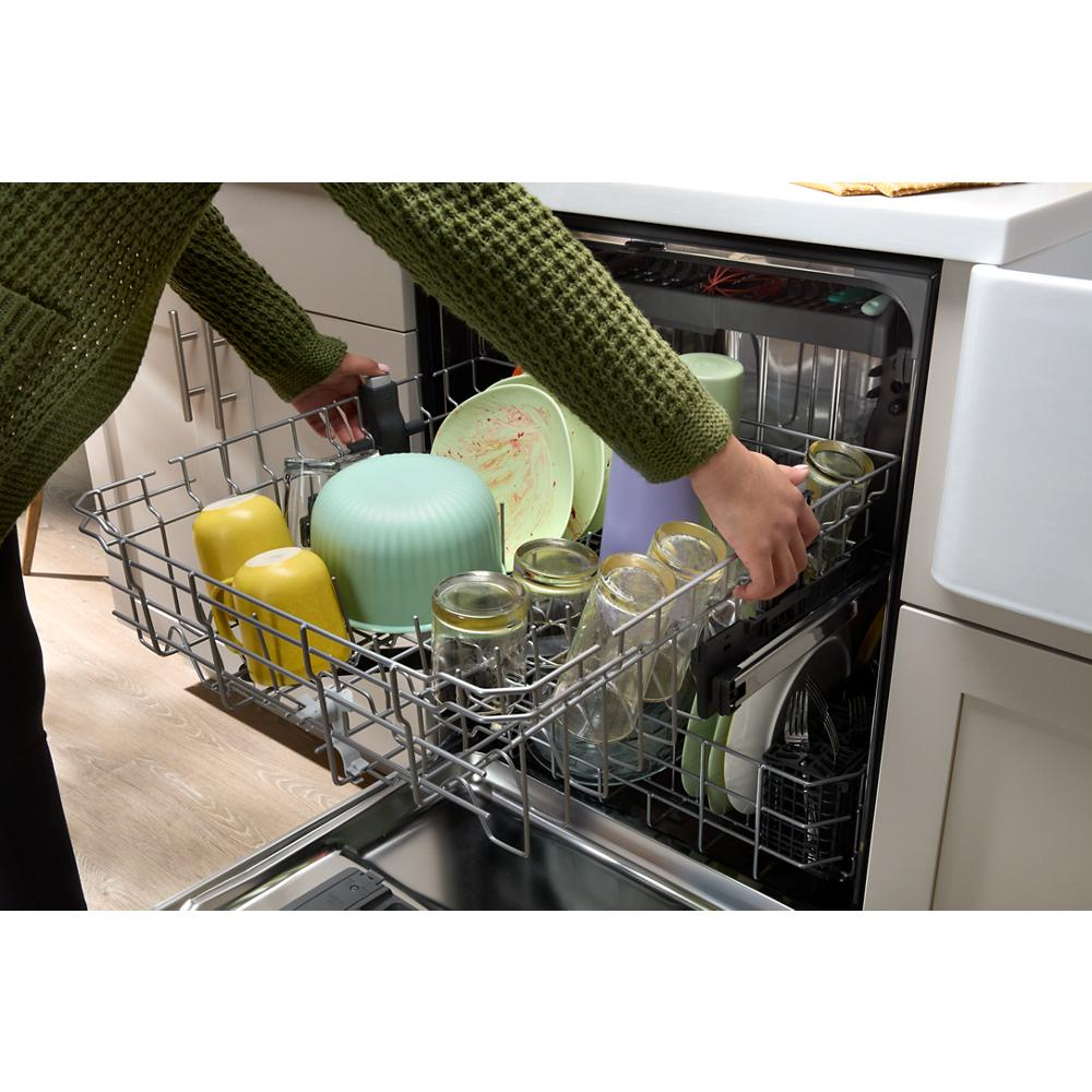Loading open dishwasher rack with dirty bowls, jars, and cups inside stainless steel appliance from Kitchen & Kitchenware collection