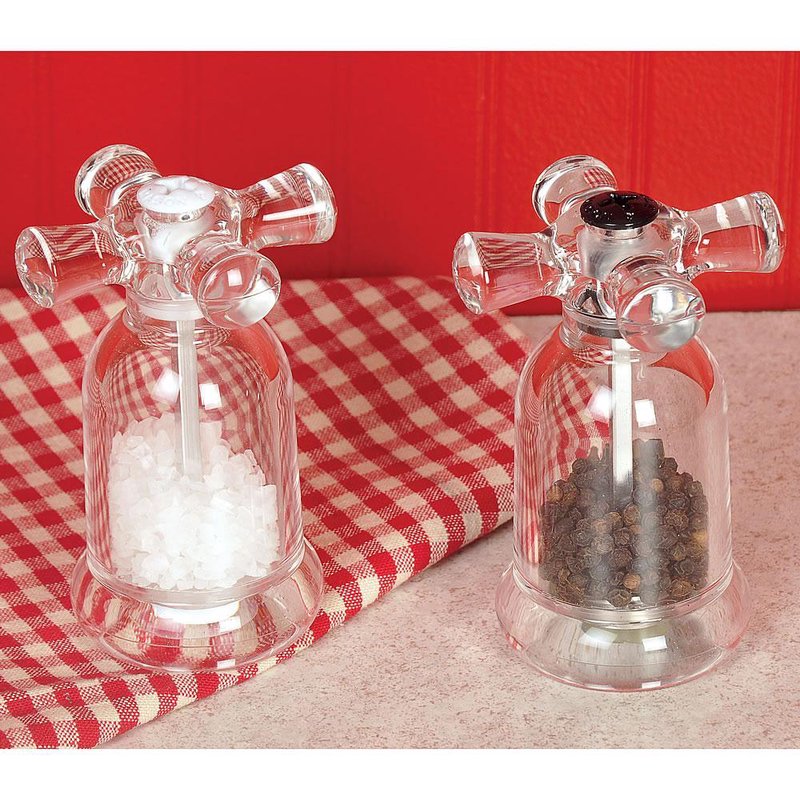 Clear acrylic salt and pepper mills with faucet-style handles on red checkered cloth in kitchenware under $100 collection