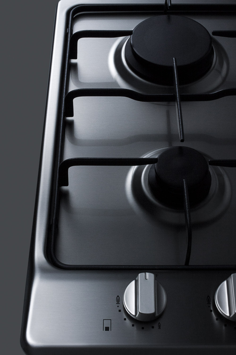Close-up of stainless steel 2-burner gas cooktop with control knobs, part of modern kitchen appliances collection.