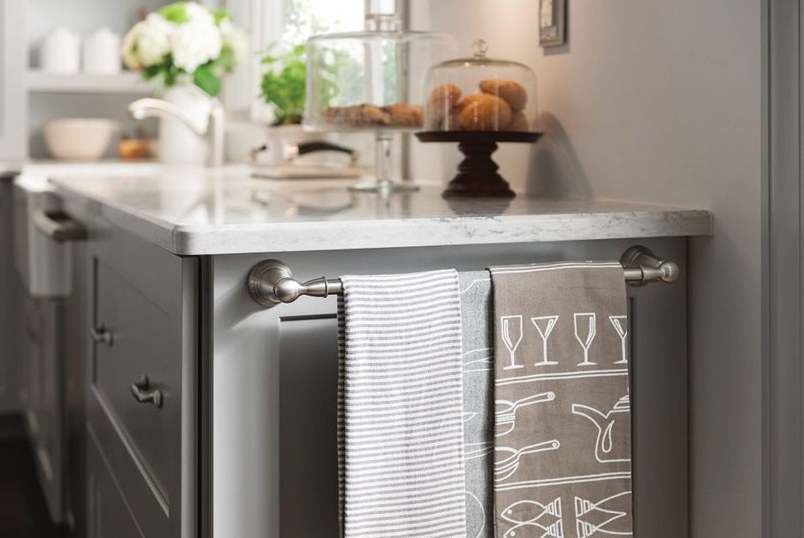 Brushed nickel towel bar mounted on kitchen island holding two patterned towels for home improvement decor