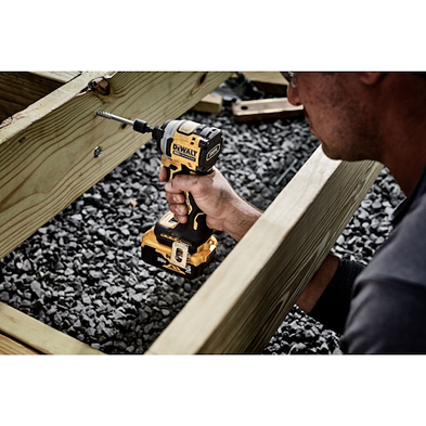 Compact cordless impact driver with 3-speed control driving screws into wooden deck framing for home improvement tasks