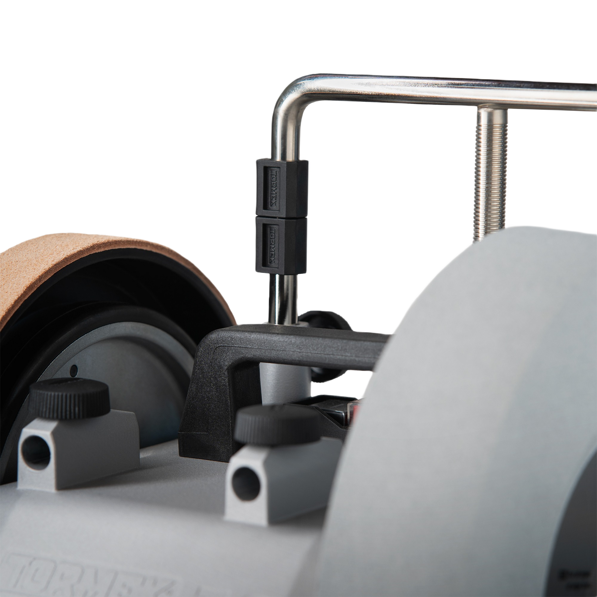 Close-up of black plastic tilt feet attached to metal frame on Tormek sharpening tool in woodworking accessories collection