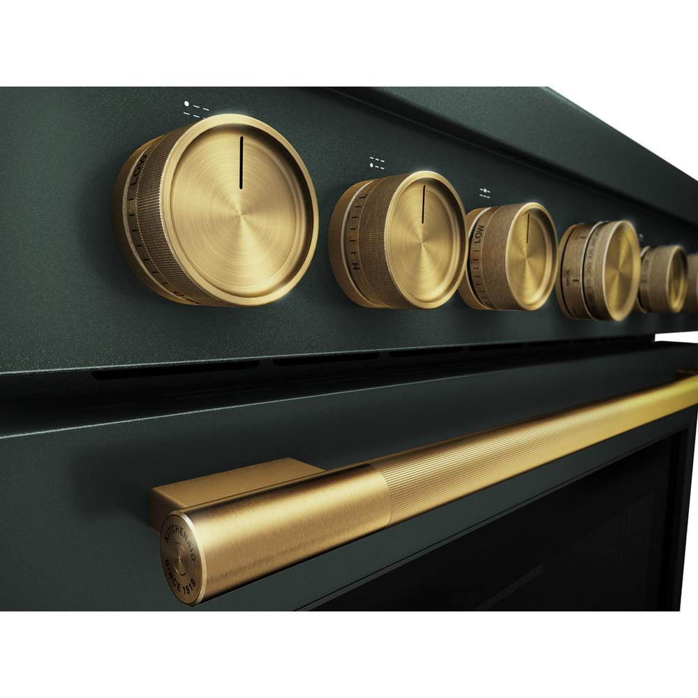 Close-up view of gold-toned control knobs and handle on dark green commercial-style dual fuel range from KitchenAid collection