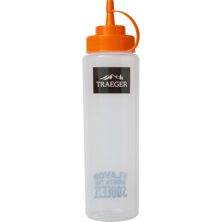 Clear plastic squeeze bottle with bright orange cap and Traeger logo for grilling tools and outdoor living accessories