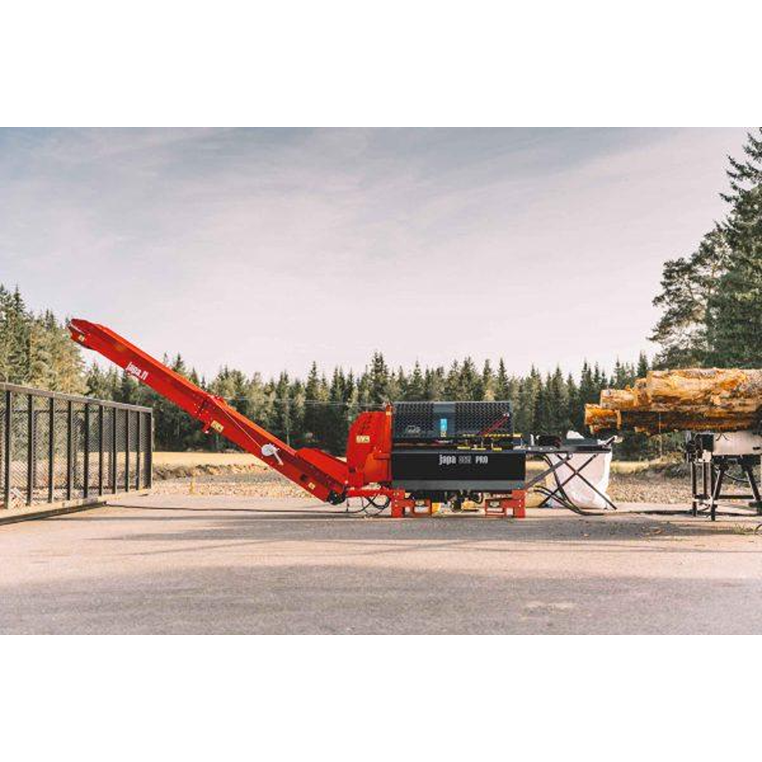 Red and black log splitter machine outdoors near stacked logs and trees in the background for tools and home improvement