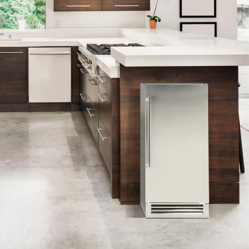 Stainless steel built-in or freestanding ice maker integrated into modern kitchen with wood cabinetry and white countertop