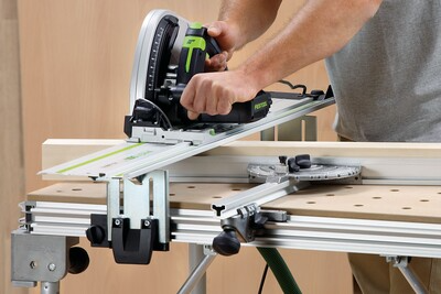 Person using Festool track saw on multifunction table with angle guide in woodworking tools and tool stands collections