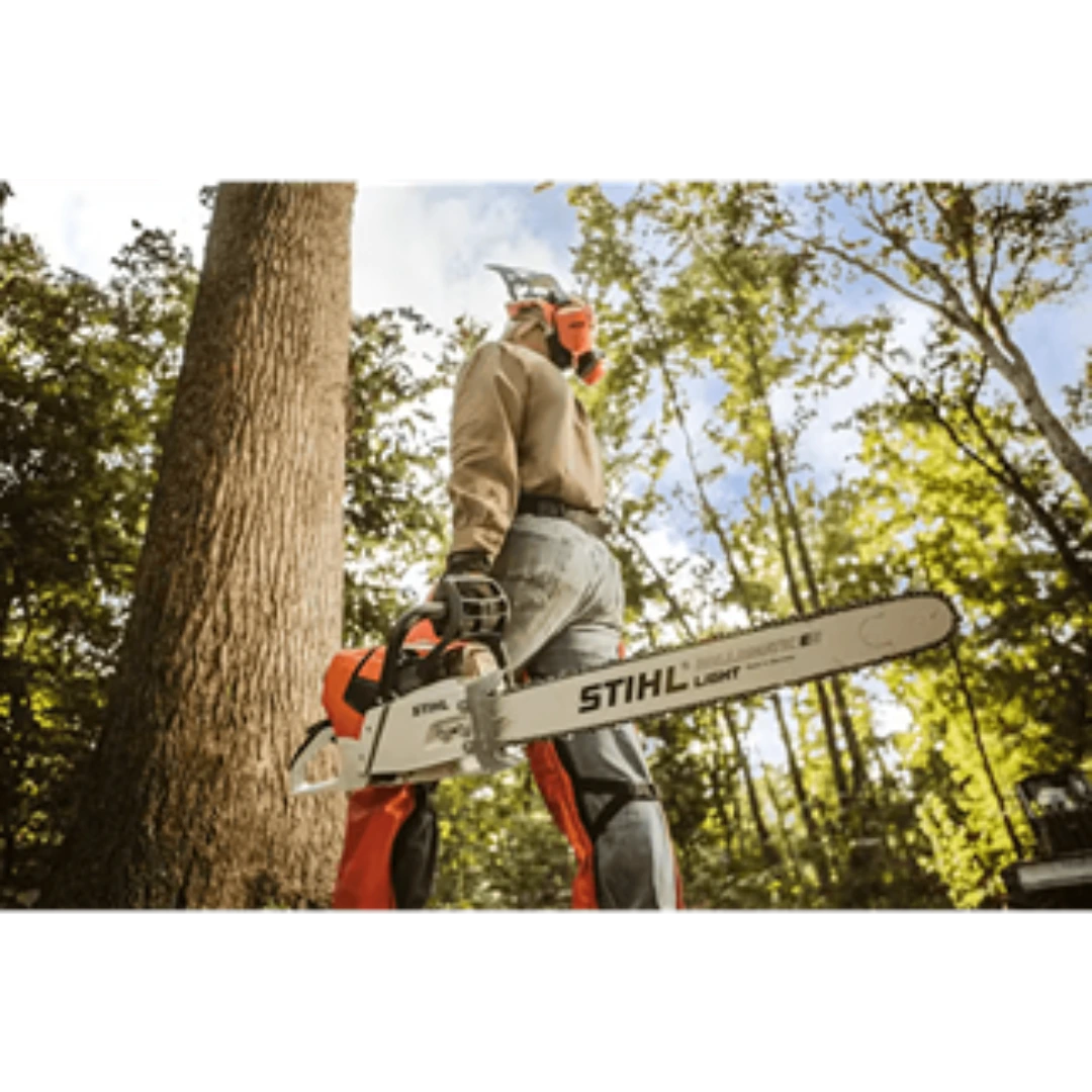 Person wearing protective gear holding a 25-inch gas-powered chainsaw for outdoor home improvement tasks