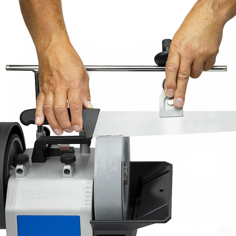 Person using universal support with micro adjust to sharpen a knife blade on a Tormek grinding machine