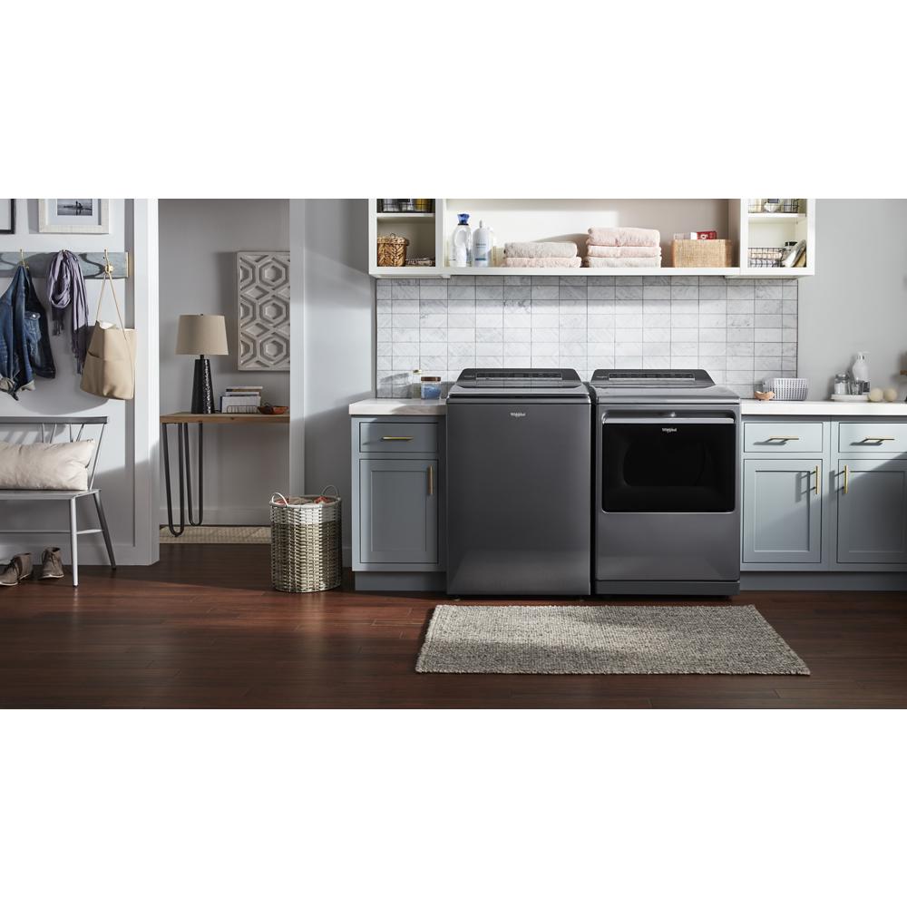 Laundry room setup with dark gray top load washer and advanced moisture sensing gas dryer in modern appliances setting