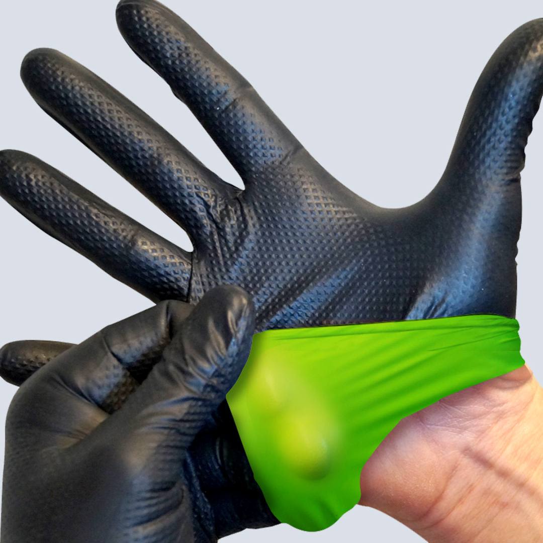 Close-up of black nitrile gloves with textured grip being pulled over hand for tools and home use