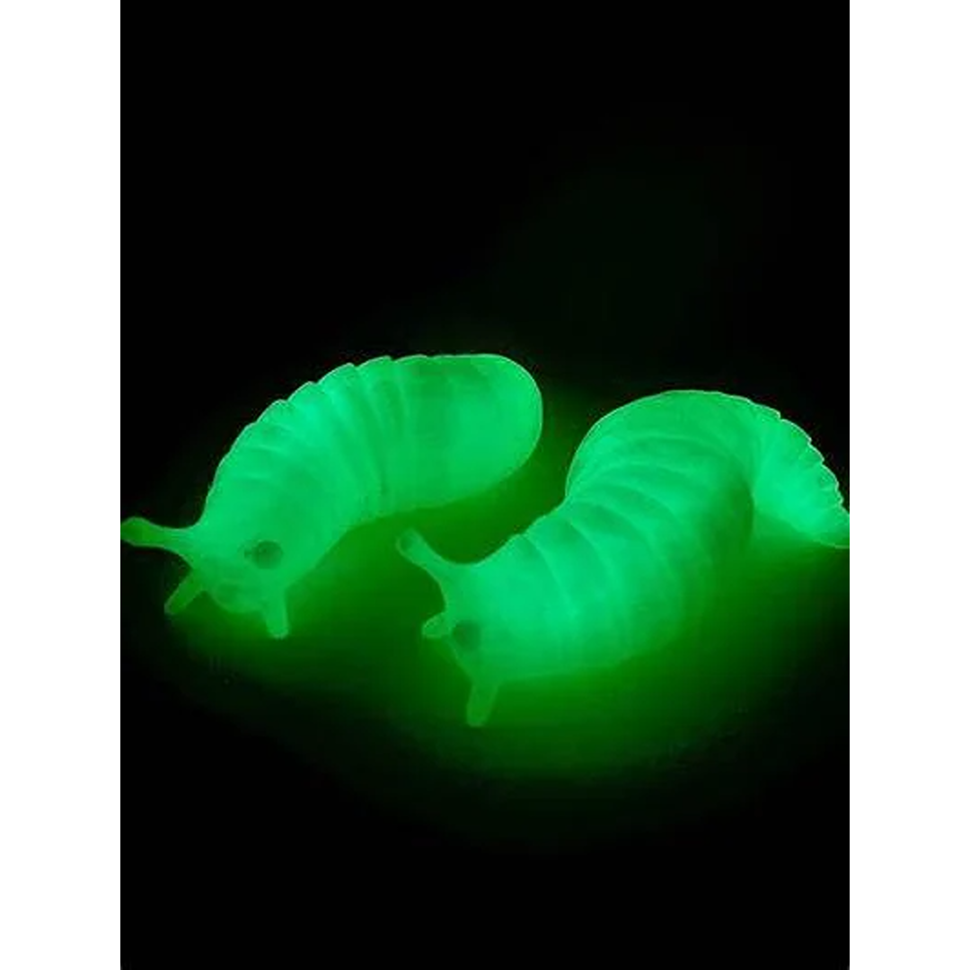 Two glowing green slug-shaped fishing baits designed for nighttime use in outdoor activities.