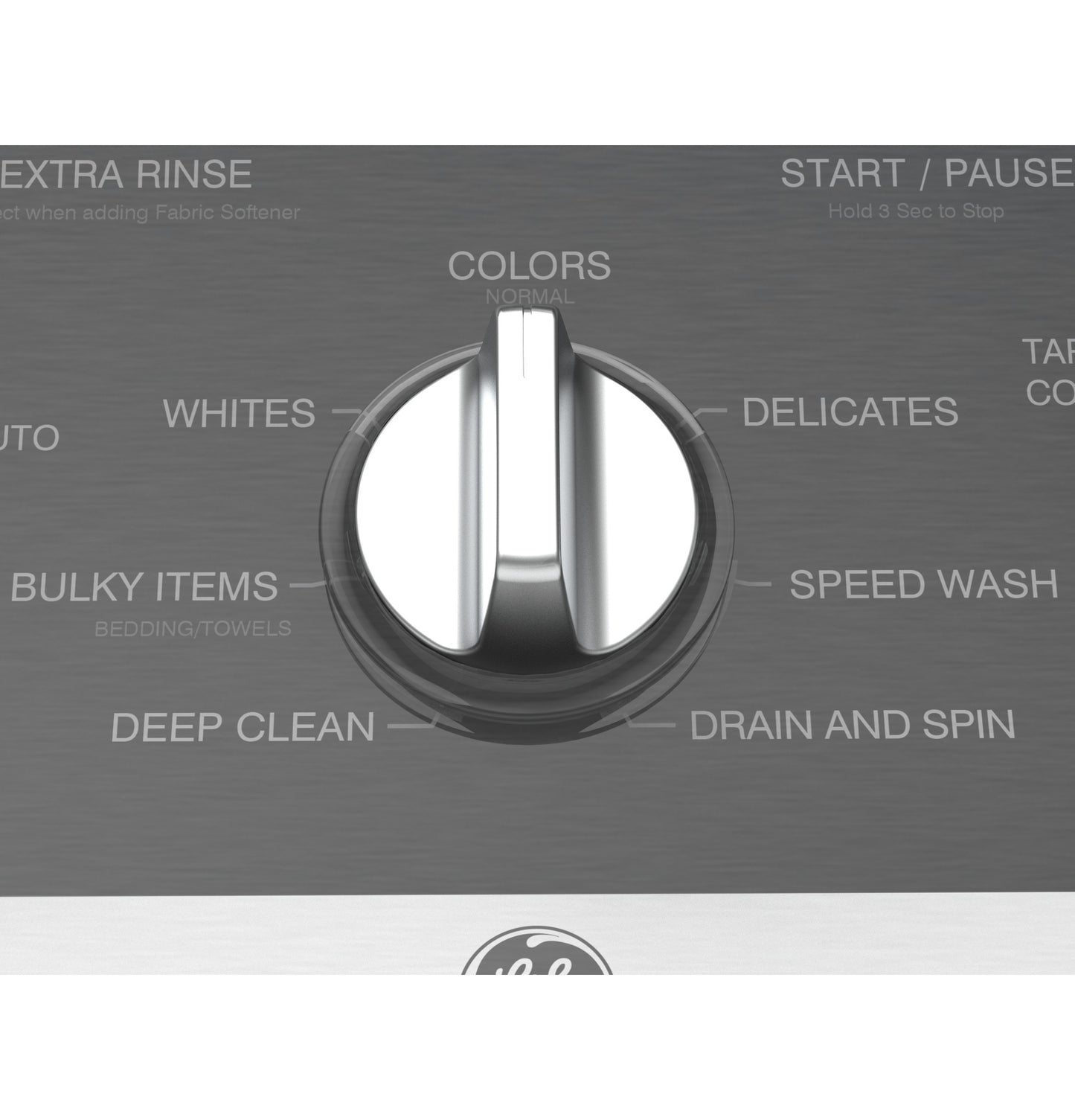 Close-up of stainless steel washer control knob with cycle options including colors, whites, delicates, and speed wash