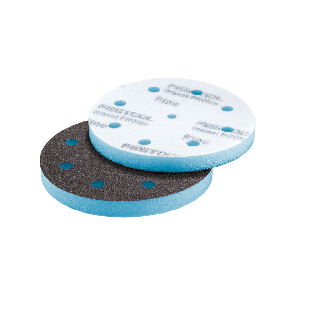 Two round foam-backed sanding discs with perforations for detailed surface preparation in power tool accessories