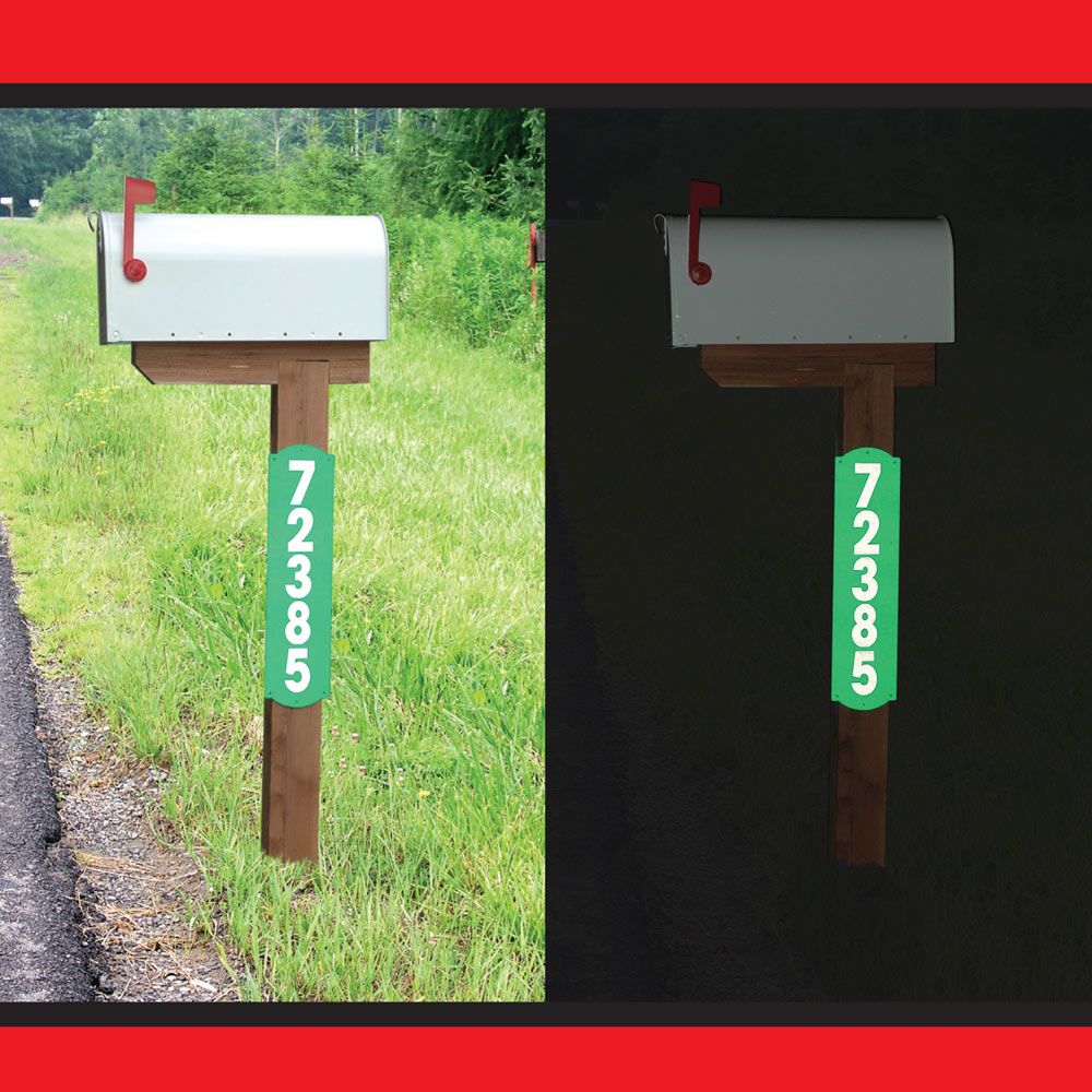 Reflective green address sign with white numbers on wooden mailbox post shown in daylight and darkness