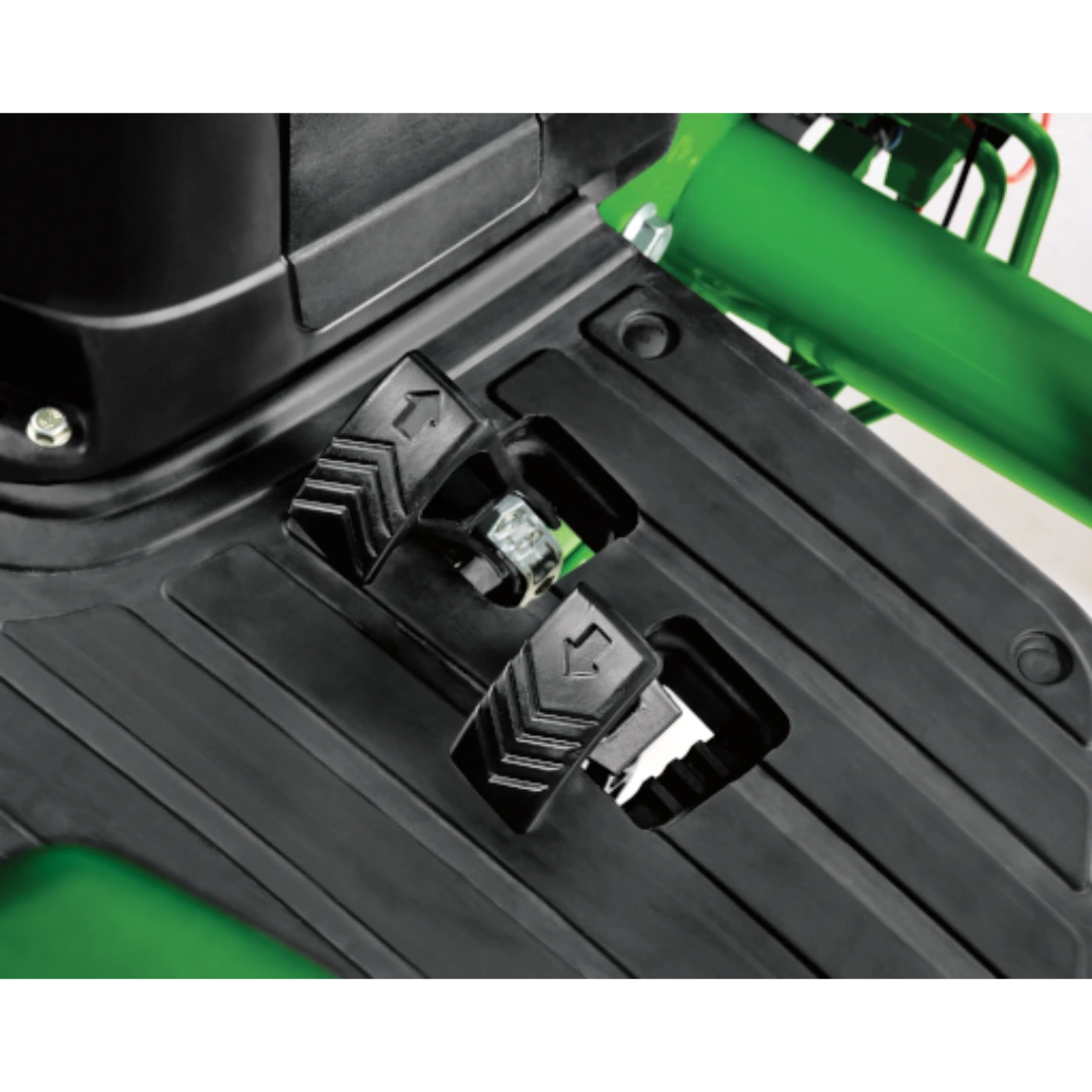 Close-up of two black metal foot pedals with arrow markings on the operator floorboard of a green John Deere 4044R Compact Tractor in Outdoor Power Equipment at Hartville Hardware.