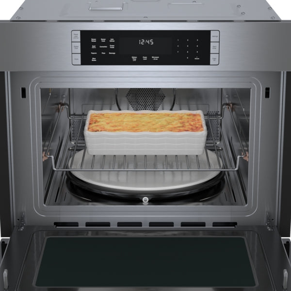 Open stainless steel speed oven from Bosch featuring baked casserole inside and digital control panel from Wall Ovens collection