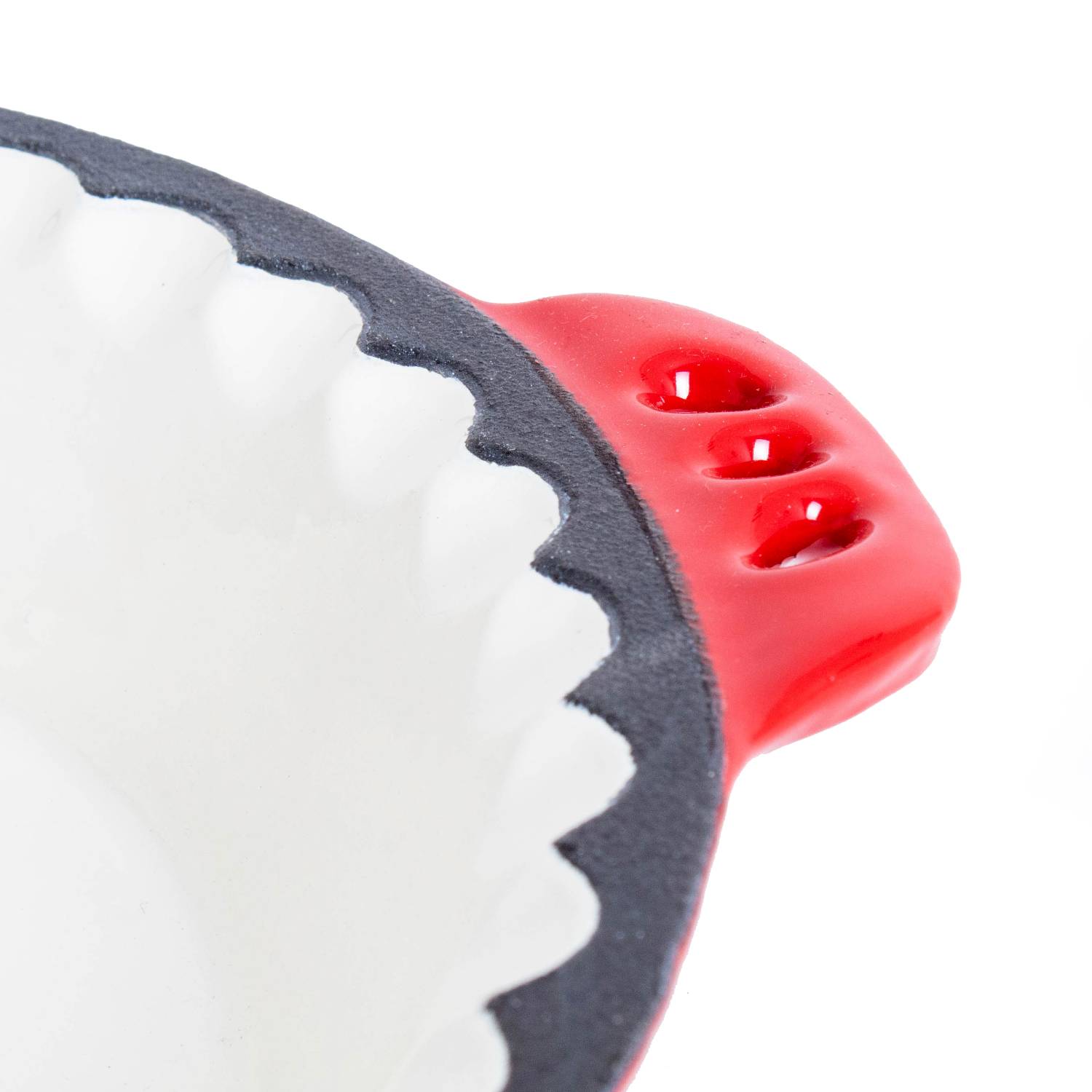 Close-up of red handled cast iron pie pan with crimped edges from kitchenware collection under $50