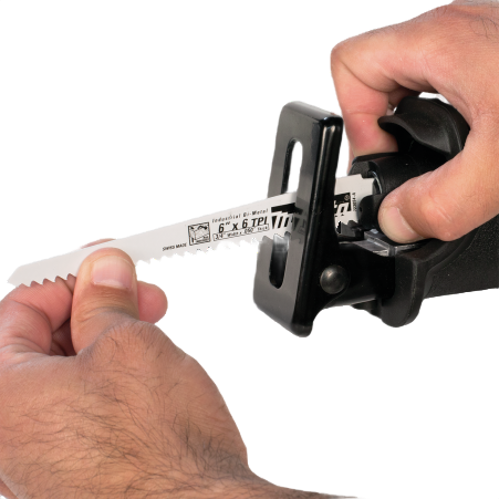 Person inserting a new saw blade into a cordless reciprocating saw for home improvement tasks