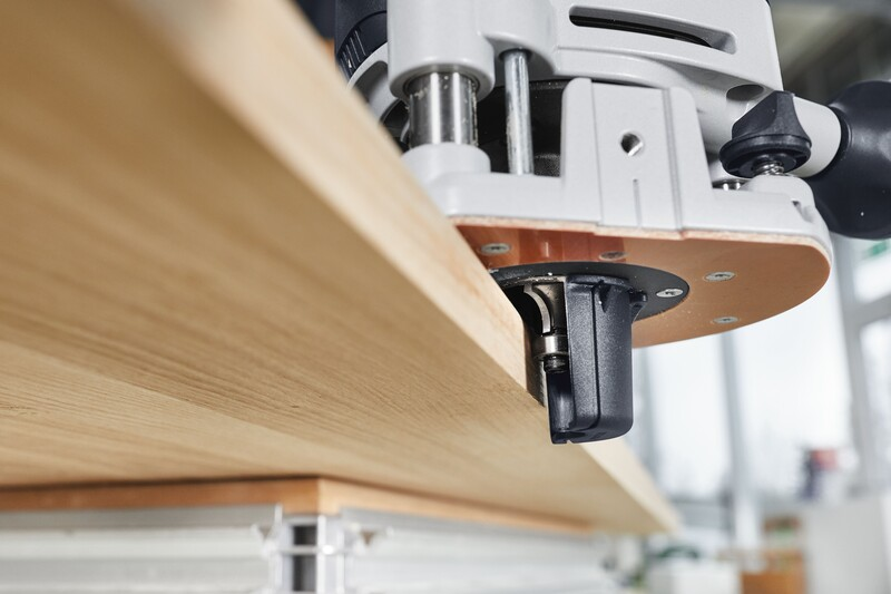 Close-up of a woodworking router with a chip catcher attached, used in tool accessories and home improvement collections