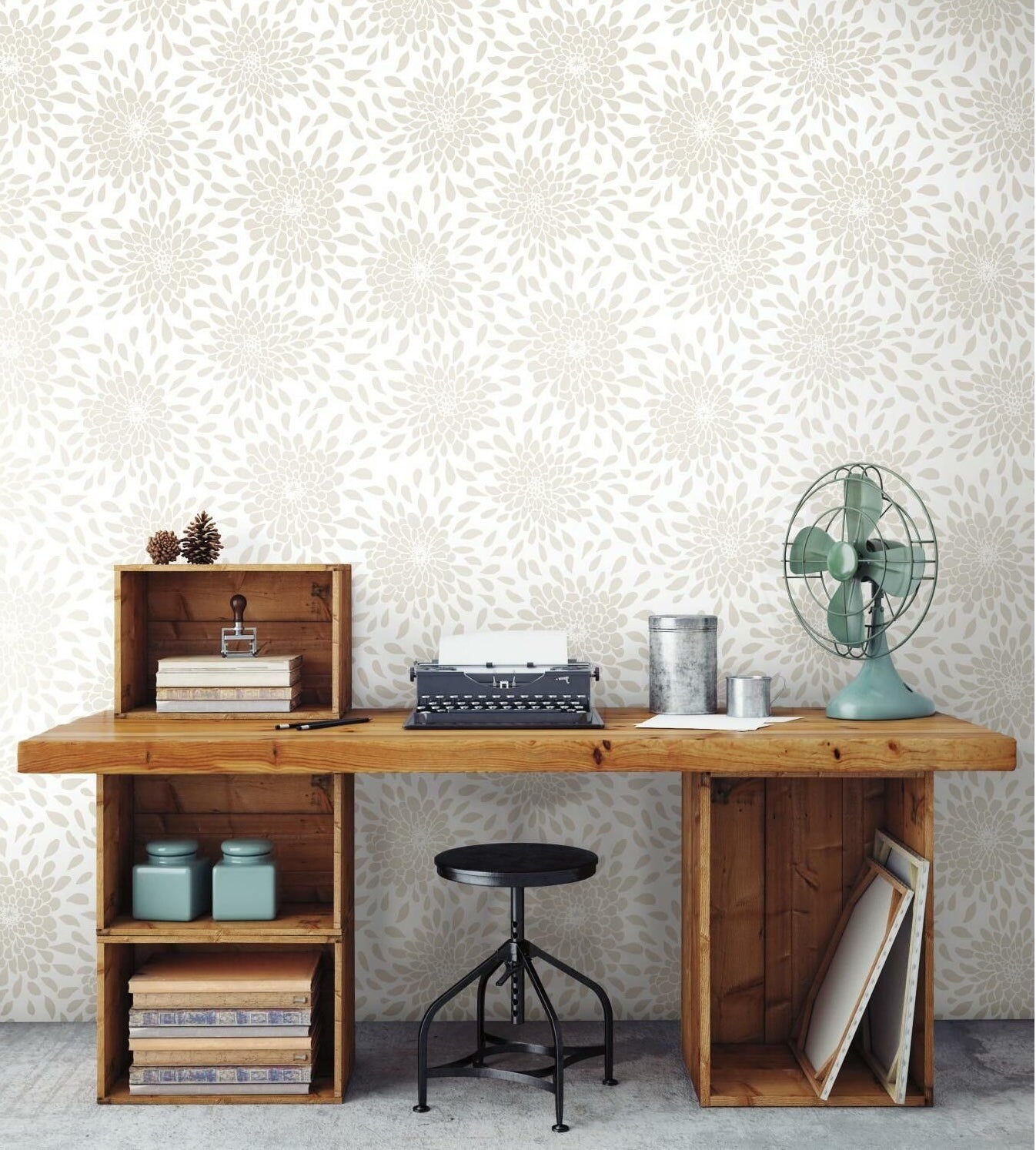 Workspace with vintage wooden desk, black stool, retro fan, and neutral floral pattern peel and stick wallpaper