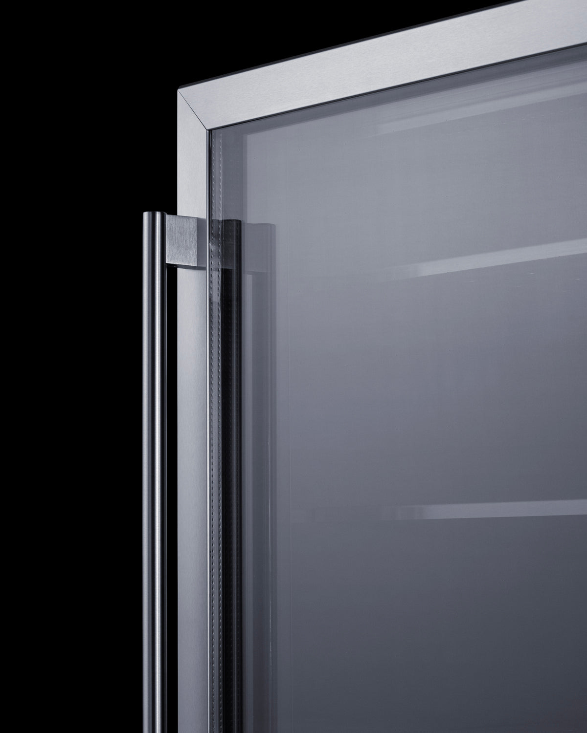 Close-up of stainless steel handle and clear glass door on commercial undercounter freezer for kitchen use