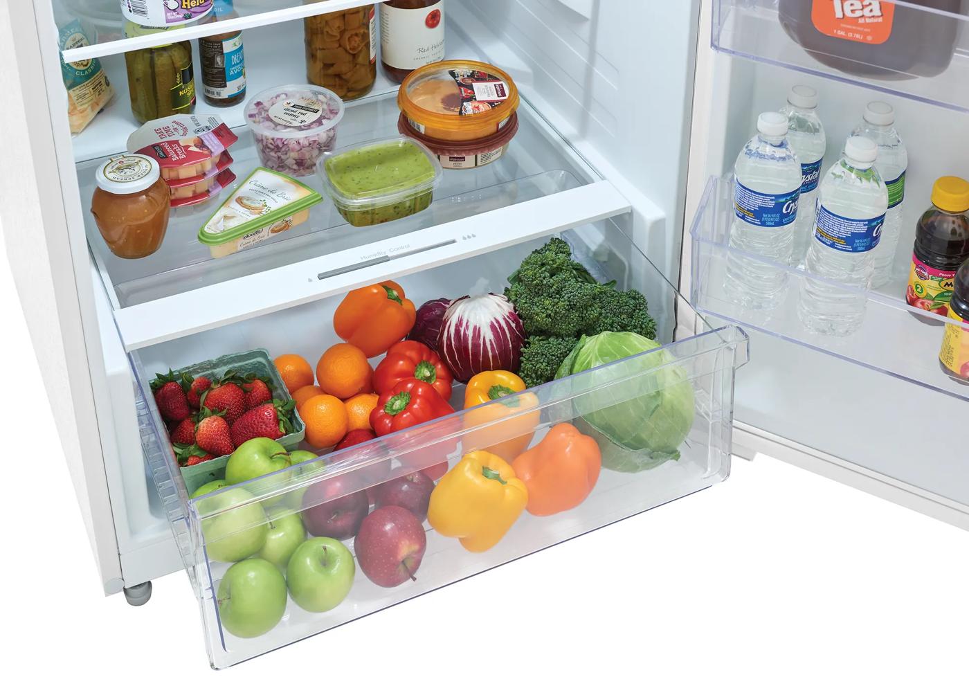 Open refrigerator drawer filled with fresh fruits and vegetables for kitchen and appliance use