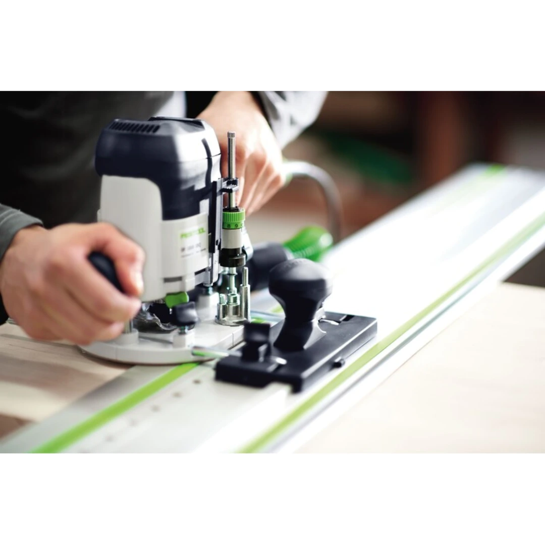 Festool woodworking router guided along a precision rail track for clean, accurate cabinet and hardware installation cuts