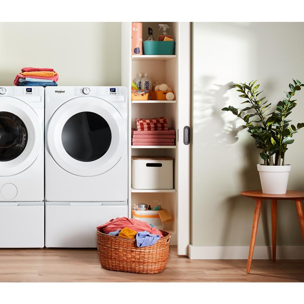 White front load electric dryer with digital controls next to matching washer in modern laundry room setting